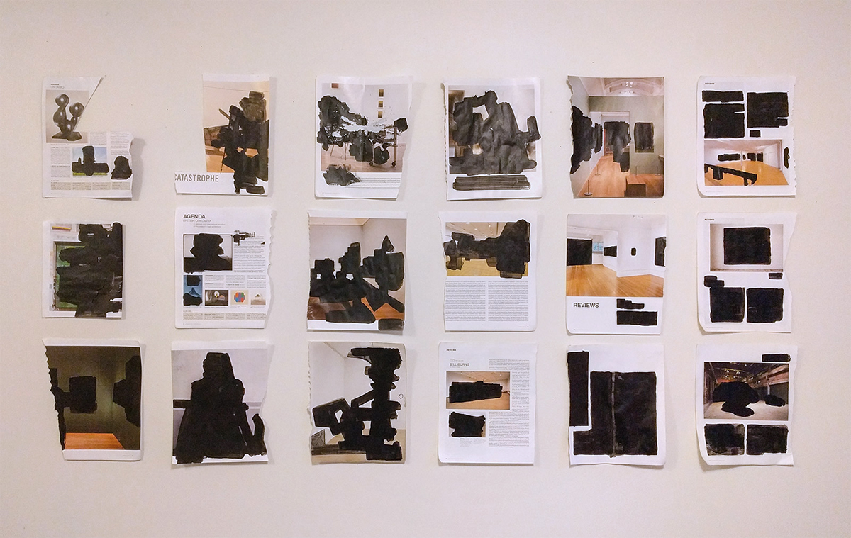 Eighteen magazine pages of blackout drawings pinned to wall in three rows of six. 